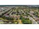 Expansive aerial view of a residential neighborhood featuring tree-lined streets, community lakes, and well-spaced homes at 5056 Gandross Ln, Mount Dora, FL 32757