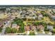 An aerial view showcasing a neighborhood with well-maintained homes, green spaces, and community lakes at 5056 Gandross Ln, Mount Dora, FL 32757