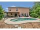 The backyard boasts a kidney shaped pool and covered patio, perfect for outdoor entertaining and relaxation at 5056 Gandross Ln, Mount Dora, FL 32757