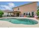 Spacious backyard with a kidney-shaped pool, patio, and ample space for outdoor enjoyment, enhanced by privacy landscaping at 5056 Gandross Ln, Mount Dora, FL 32757