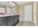 Bathroom features marble countertops, black cabinets, modern lighting and a tile floor at 5056 Gandross Ln, Mount Dora, FL 32757