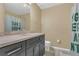 Bathroom featuring dark cabinets, marble countertops, double sinks, and tile floors at 5056 Gandross Ln, Mount Dora, FL 32757