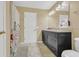 Bathroom featuring marble countertops, dark cabinets, modern lighting, and a tile floor at 5056 Gandross Ln, Mount Dora, FL 32757