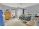 Bedroom with neutral carpet, window, ceiling fan, closet, and various toys at 5056 Gandross Ln, Mount Dora, FL 32757