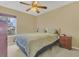 Bedroom featuring a ceiling fan, neutral walls, light colored carpet, and a window at 5056 Gandross Ln, Mount Dora, FL 32757