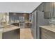Modern kitchen featuring granite countertops, stainless steel appliances, and dark wood cabinets at 5056 Gandross Ln, Mount Dora, FL 32757