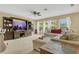 Spacious living room featuring plush seating, large windows, and a ceiling fan at 5056 Gandross Ln, Mount Dora, FL 32757