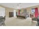 Large main bedroom with neutral carpet, furniture, windows, and a ceiling fan at 5056 Gandross Ln, Mount Dora, FL 32757