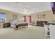 Spacious main bedroom features neutral walls, large bed, a ceiling fan and ample sunlight at 5056 Gandross Ln, Mount Dora, FL 32757
