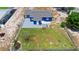 Aerial view of home, including backyard with mature tree, fence, and patio at 507 Raymond Ave, Frostproof, FL 33843