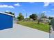Spacious backyard featuring a large grass area, mature trees and a chain-link fence at 507 Raymond Ave, Frostproof, FL 33843