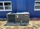 Image of a Goodman air conditioner unit outside the house surrounded by two windows at 507 Raymond Ave, Frostproof, FL 33843