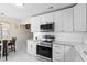 Modern kitchen features stainless steel appliances, granite countertops, and sleek white cabinetry at 507 Raymond Ave, Frostproof, FL 33843