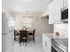 Bright kitchen nook featuring modern appliances, white cabinets, and a cozy dining area at 507 Raymond Ave, Frostproof, FL 33843