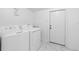 Functional laundry room equipped with washer and dryer; freshly painted in a neutral color at 507 Raymond Ave, Frostproof, FL 33843