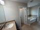 Well-lit bathroom featuring a vanity and a separate tub and shower area at 5213 Northlawn Way, Orlando, FL 32811
