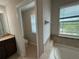 Bright bathroom featuring double windows, soaking tub, and access to the water closet at 5213 Northlawn Way, Orlando, FL 32811