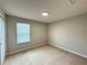 Cozy carpeted bedroom with a window that offers natural light and a spacious closet at 5213 Northlawn Way, Orlando, FL 32811