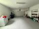Spacious garage with ample storage shelves and overhead door, perfect for parking and projects at 5213 Northlawn Way, Orlando, FL 32811