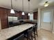 Kitchen featuring stainless steel appliances, granite countertops, and barstool seating at 5213 Northlawn Way, Orlando, FL 32811