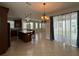 Open kitchen and dining area with tile flooring and modern chandelier at 5213 Northlawn Way, Orlando, FL 32811