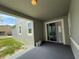 An outdoor patio area with a gray painted floor and a sliding glass door at 5213 Northlawn Way, Orlando, FL 32811