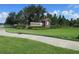 Community entrance sign for Millennia Park with well-maintained landscaping at 5213 Northlawn Way, Orlando, FL 32811