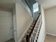 Carpeted staircase with white railing leads to the upper level of the home at 5213 Northlawn Way, Orlando, FL 32811