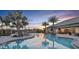 Stunning community pool with palm trees, lounge chairs, and ample seating areas, perfect for relaxation at 5362 Spoonflower Ct, St Cloud, FL 34771