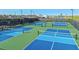 Community pickleball courts with vibrant blue and green surfaces, providing a fun recreational amenity at 5362 Spoonflower Ct, St Cloud, FL 34771