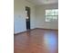 Hardwood floors and a window provide natural light, offering a cozy atmosphere at 5441 Arpana Dr, Orlando, FL 32839