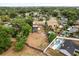 Wide aerial shot showing the home in a neighborhood setting with a large fenced lot and screened in pool at 5606 Eggleston Ave, Orlando, FL 32810