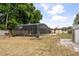 View of the backyard with a screened in pool, shed, and space for outdoor activities at 5606 Eggleston Ave, Orlando, FL 32810
