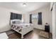 Cozy bedroom with wood floors, two windows providing natural light, and closet storage at 5606 Eggleston Ave, Orlando, FL 32810