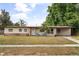 Charming single-story home featuring a well-kept lawn, quaint sitting area, and a neutral color palette at 5606 Eggleston Ave, Orlando, FL 32810