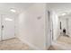 Bright hallway leading to various rooms, showcasing tile flooring and a clean aesthetic at 5606 Eggleston Ave, Orlando, FL 32810