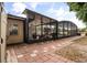 Outdoor patio space with pavers, a ceiling fan, a grill, and access to the screened in pool at 5606 Eggleston Ave, Orlando, FL 32810