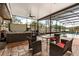 Screened-in patio with hot tub, dining, seating area, and view of pool and backyard at 5606 Eggleston Ave, Orlando, FL 32810