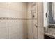Tiled shower with built-in shelving and decorative accent tiles at 5606 Eggleston Ave, Orlando, FL 32810