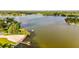 Scenic aerial view showcasing a serene lake with a pier and lush surroundings at 604 Chestnut Oak Cir # 106, Altamonte Springs, FL 32701