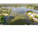 Expansive aerial view of a lake surrounded by lush greenery, community features, and residential areas at 604 Chestnut Oak Cir # 106, Altamonte Springs, FL 32701