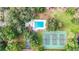 Aerial view of community pool, tennis court, and basketball court surrounded by mature trees at 604 Chestnut Oak Cir # 106, Altamonte Springs, FL 32701
