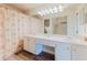 Bright bathroom features double sinks, vanity lighting, and a bathtub with a patterned shower curtain at 604 Chestnut Oak Cir # 106, Altamonte Springs, FL 32701