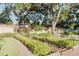 Inviting exterior view with landscaped pathway, covered entrance, and mature trees offering shade and charm at 604 Chestnut Oak Cir # 106, Altamonte Springs, FL 32701
