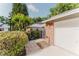 Townhome exterior featuring a brick accented garage and a meticulously maintained front garden at 604 Chestnut Oak Cir # 106, Altamonte Springs, FL 32701