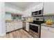 Modern kitchen with stainless steel appliances, white cabinetry, and granite countertops at 604 Chestnut Oak Cir # 106, Altamonte Springs, FL 32701