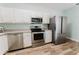 Updated kitchen with stainless steel appliances, white cabinets, and modern countertops at 604 Chestnut Oak Cir # 106, Altamonte Springs, FL 32701