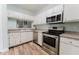 Well-lit kitchen with stainless steel appliances, white cabinets, and modern countertops at 604 Chestnut Oak Cir # 106, Altamonte Springs, FL 32701