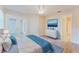 Bright main bedroom boasts light wood floors, white walls, and access to the balcony and ensuite bath at 604 Chestnut Oak Cir # 106, Altamonte Springs, FL 32701