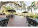 Outdoor patio area with brick pavers, patio furniture, and umbrellas for outdoor dining and relaxation at 604 Chestnut Oak Cir # 106, Altamonte Springs, FL 32701